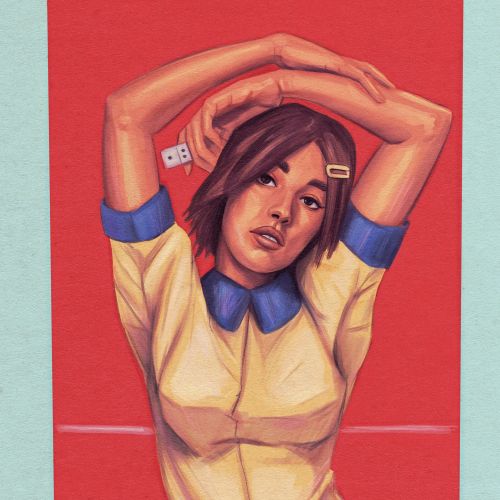 Woman in yellow dress with arms raised against red domino backdrop