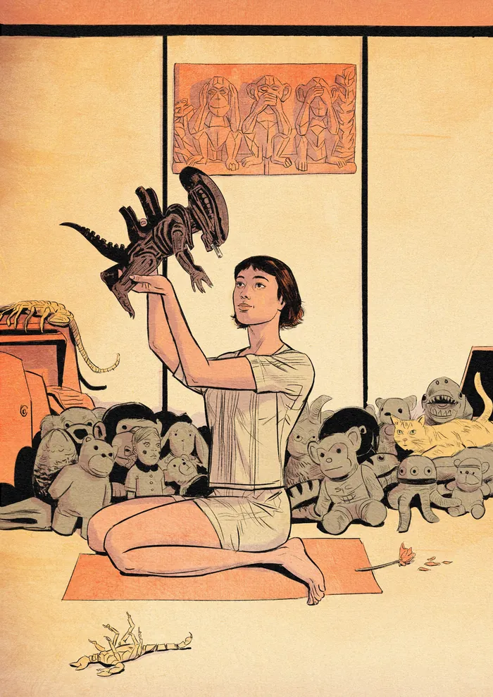 Girl playing with alien creature toy among stuffed animals