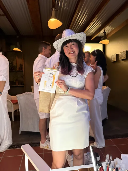 Guest holding illustration at Amazon White Out Party by Sunwoo Mansour