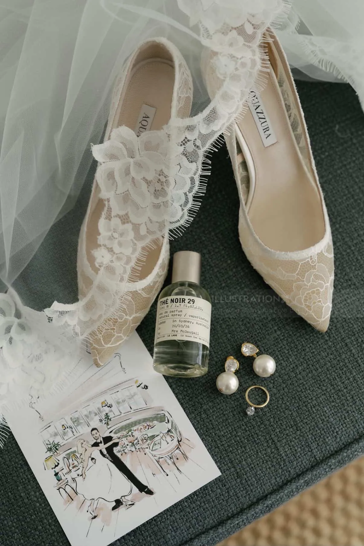 Bridal shoes, perfume, earrings, and ring on lace fabric by Sunwoo Mansour