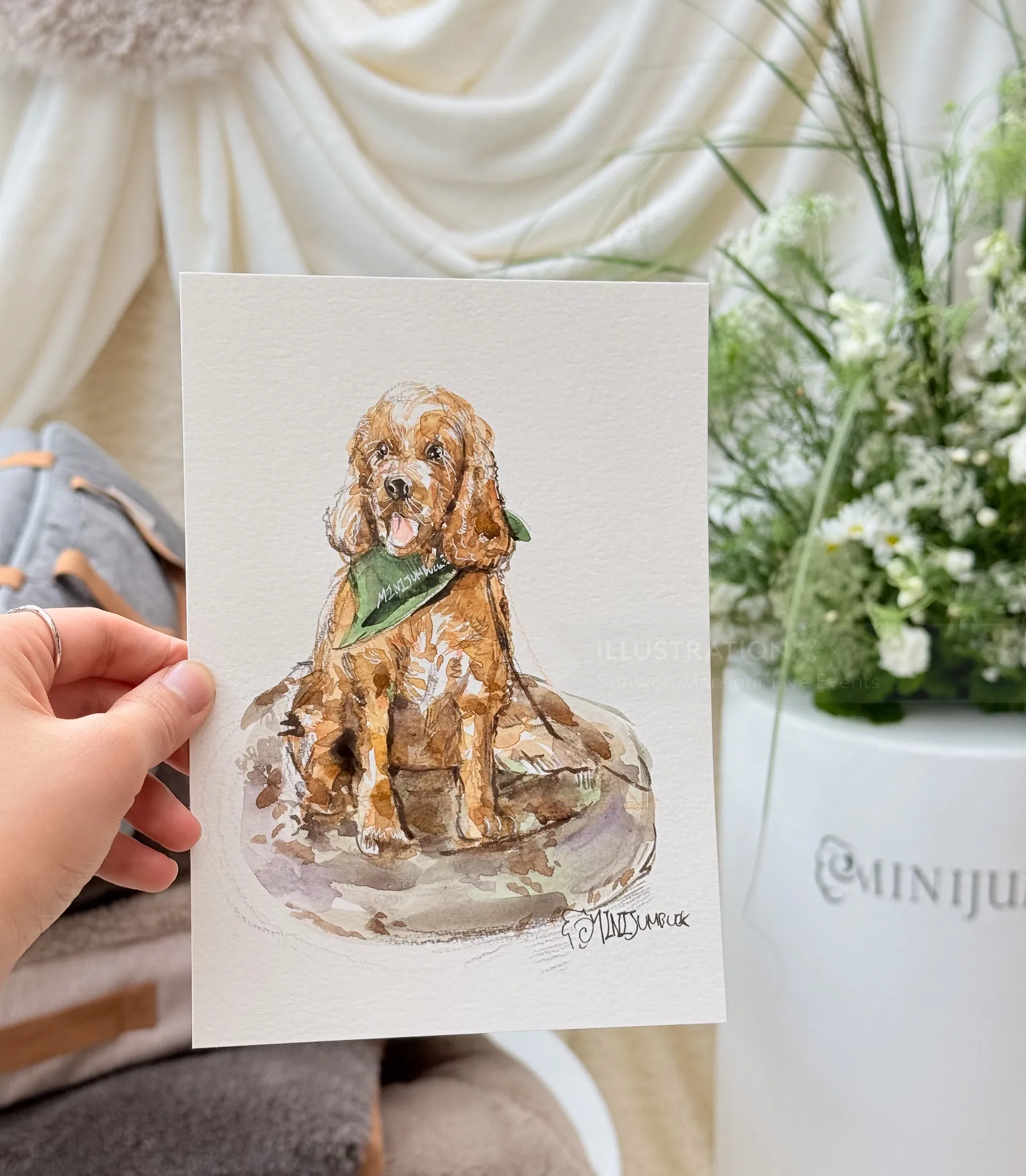 Hand holding a live pet portrait illustration of a dog by Sunwoo Mansour