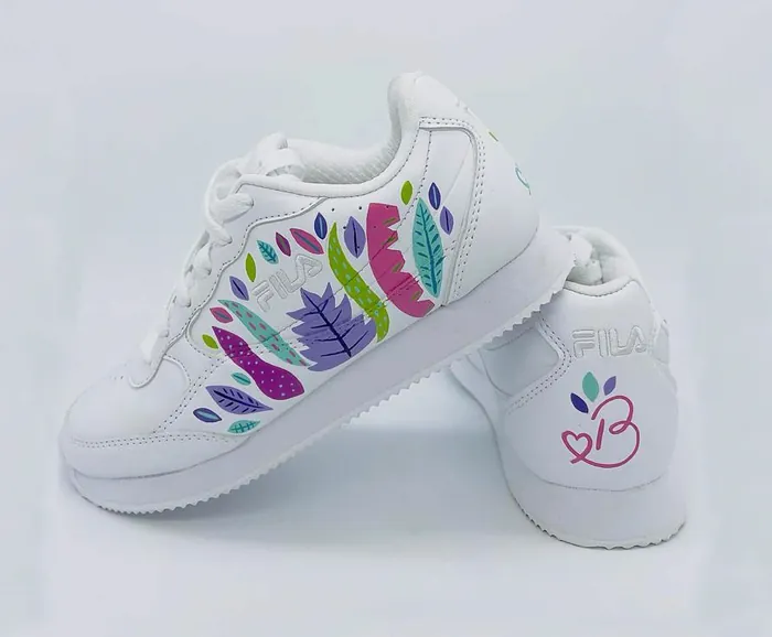 White FILA sneakers decorated with colorful leaves and a butterfly detail by Superama