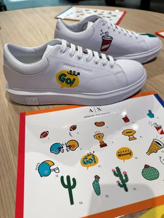 White sneakers with colorful cartoon stickers by Superama