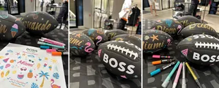 Black footballs decorated with colorful marker designs by artist Superama