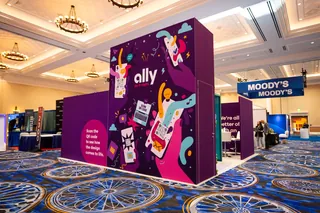 Ally booth with purple graphics and conference hall background