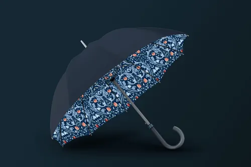 Black umbrella showing floral patterned inside against dark background