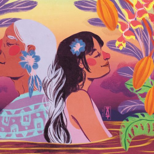 Two women with flowers in their hair surrounded by colorful plants