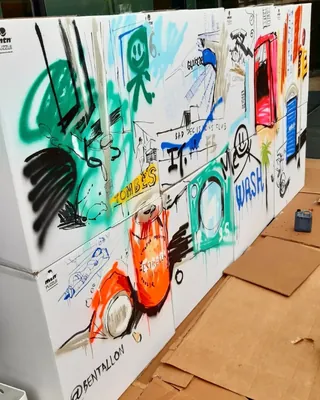 Colorful urban graffiti mural with various illustrations by Tallon Live Event Drawing