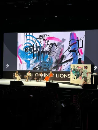 Live drawing session at Cannes Lions with abstract colorful artwork displayed