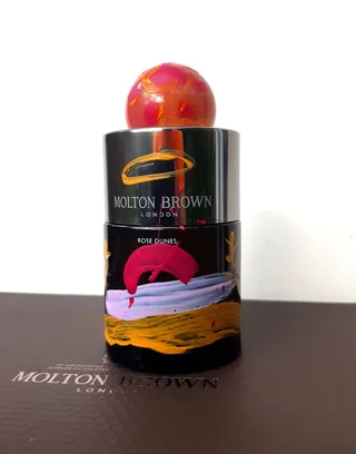 Molton Brown Rose Dunes perfume bottle with red decorative cap