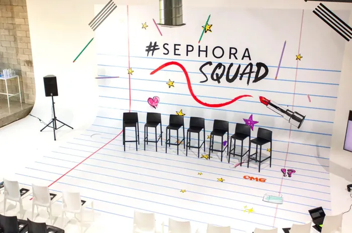 Set design with Sephora Squad logo and chairs on stage