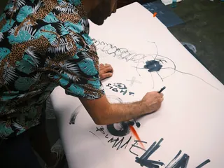 Artist sketching live event illustration on large paper