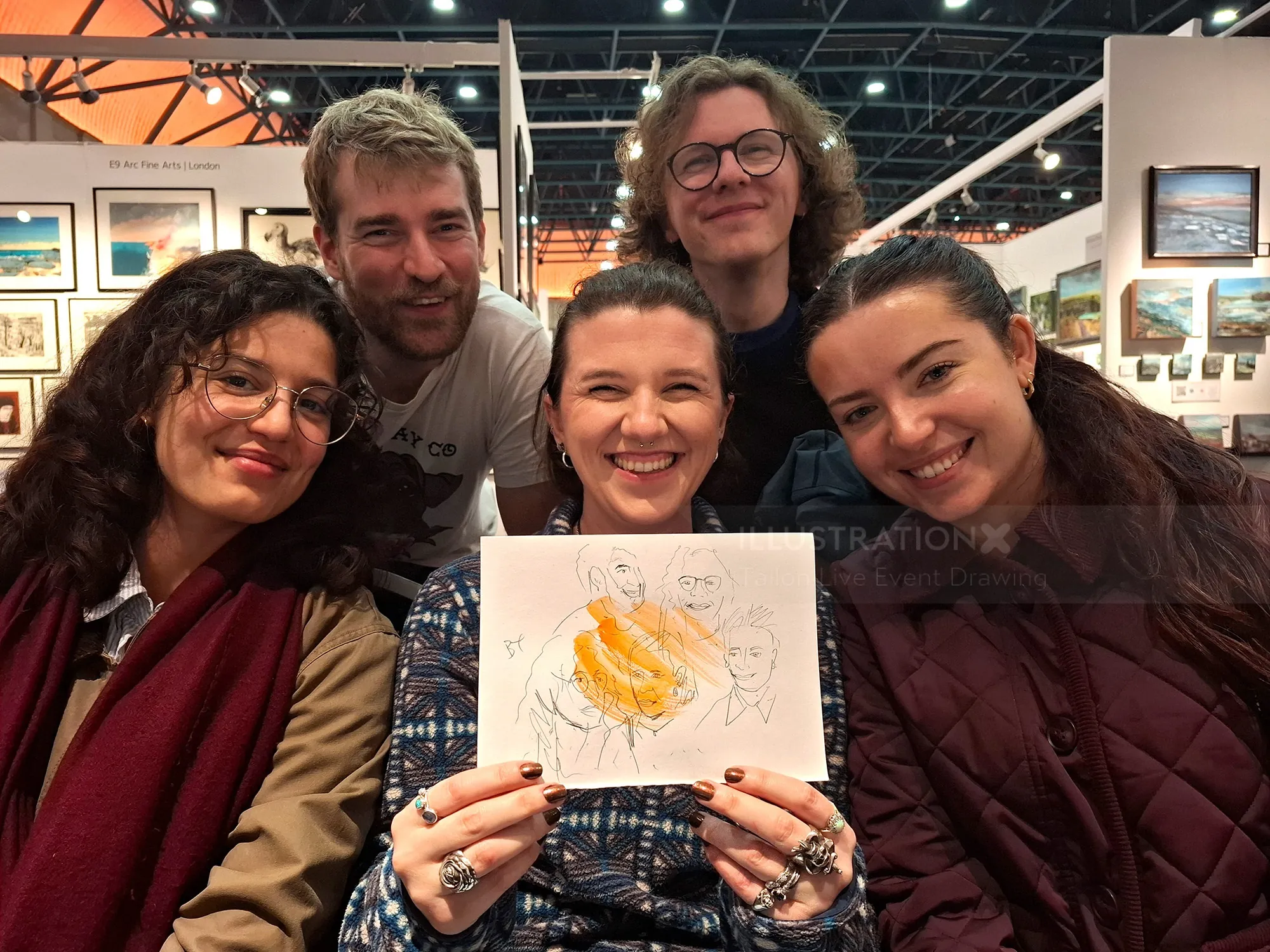 Group of five people posing with a live event sketch by Tallon Live Event Drawing