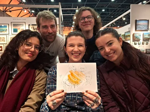 Group of five people posing with a live event sketch by Tallon Live Event Drawing