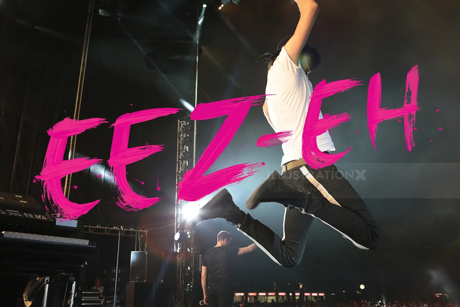 Musician jumping mid-air on stage with bright pink EEZ EH text