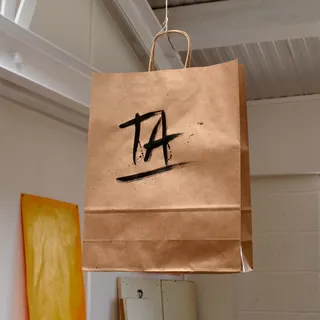 Ta lettering on carrying bag by Tallon Type