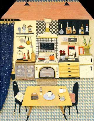 Vintage kitchen with stove, wooden table, chairs, and shelves.