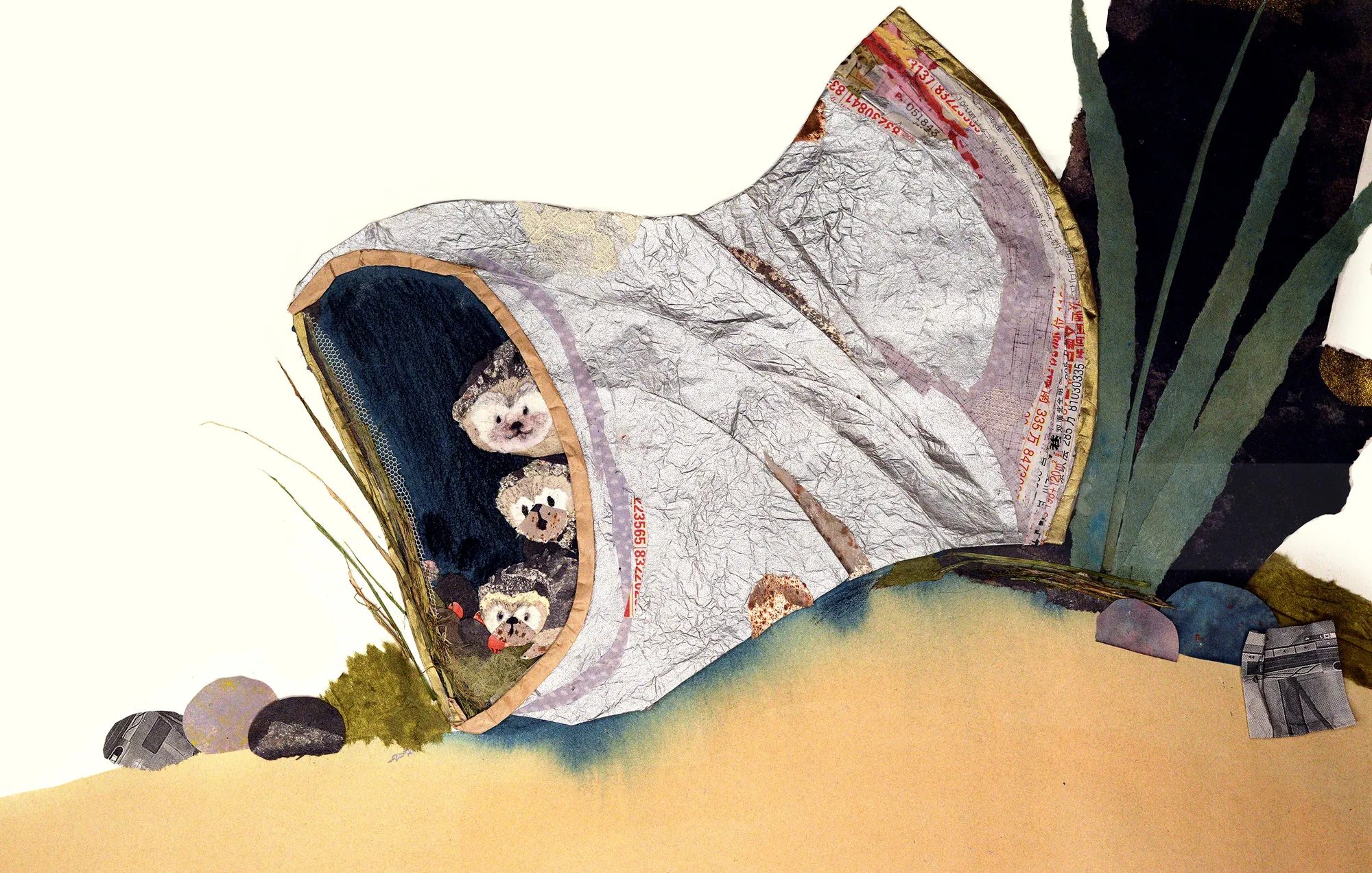 Three baby animals inside hollow tree trunk with rocks and plants