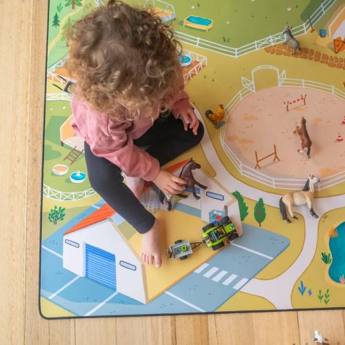 Girl playing with farm play mat