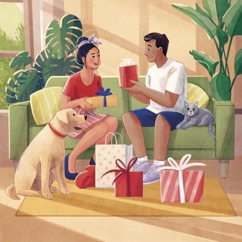 Couple sitting on couch exchanging gifts with dog and cat