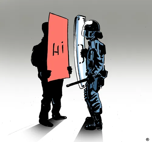 Protester holding red 'Hi' sign facing police officer in riot gear by Thilo Rothacker