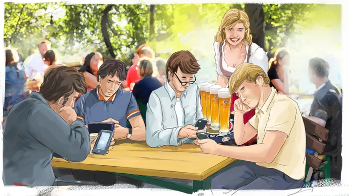 Young adults sitting at picnic table, focused on their smartphones outdoors