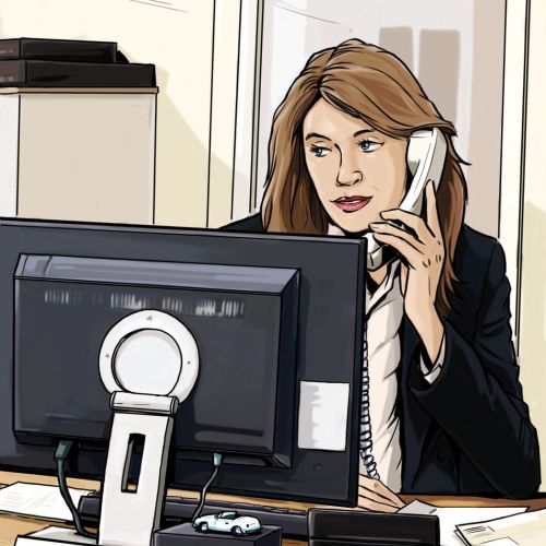 receptionist with telephone sitting in front of computer