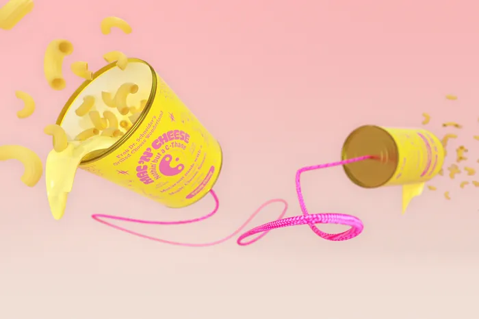 Two yellow cups connected by pink string with macaroni spilling out on pink background