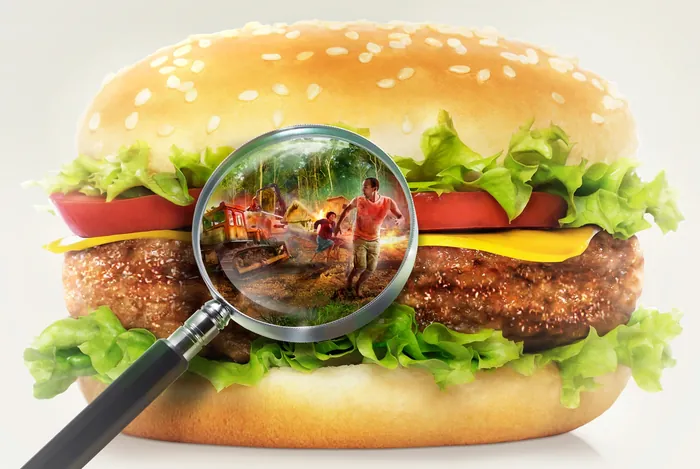 Tom Krieger artwork showing workers inside a burger through magnifying glass