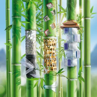 Modern metal bracelets showcased on green bamboo stalks by Tom Krieger