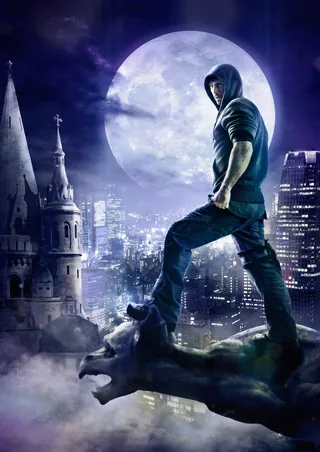 A hooded man stands on a gargoyle with a full moon and city behind, by Tom Krieger