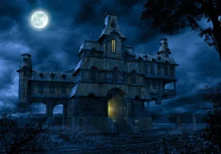 Eerie haunted mansion at night under full moon by Tom Krieger