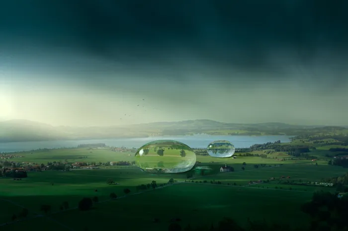 Green landscape with floating transparent bubbles by Tom Krieger