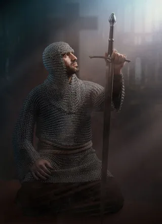 Kneeling knight in chainmail holding a sword by Tom Krieger