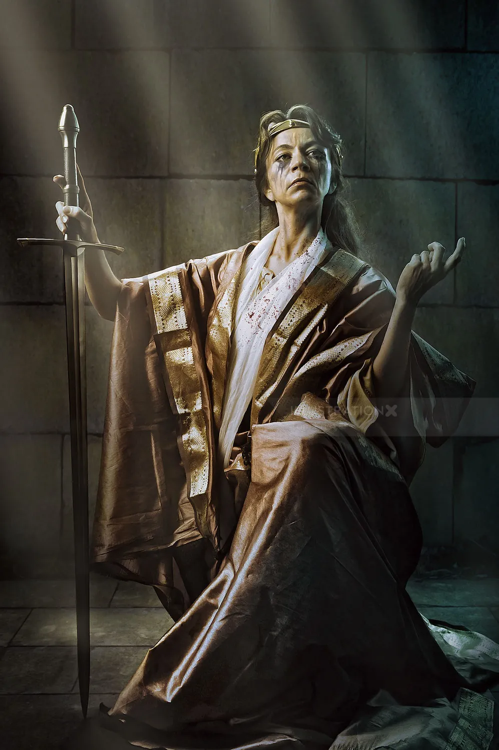 Bronze statue of a woman holding a staff, lit by beams of light, by Tom Krieger