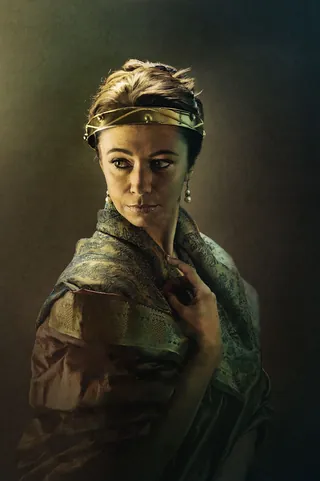 Portrait of a thoughtful woman wearing a headband and draped fabric by Tom Krieger