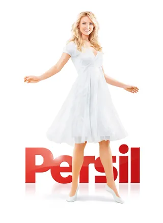 Smiling woman in white dress standing with Persil logo, artwork by Tom Krieger