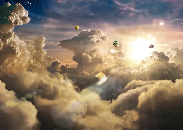 Hot air balloons floating above clouds at sunset by Tom Krieger