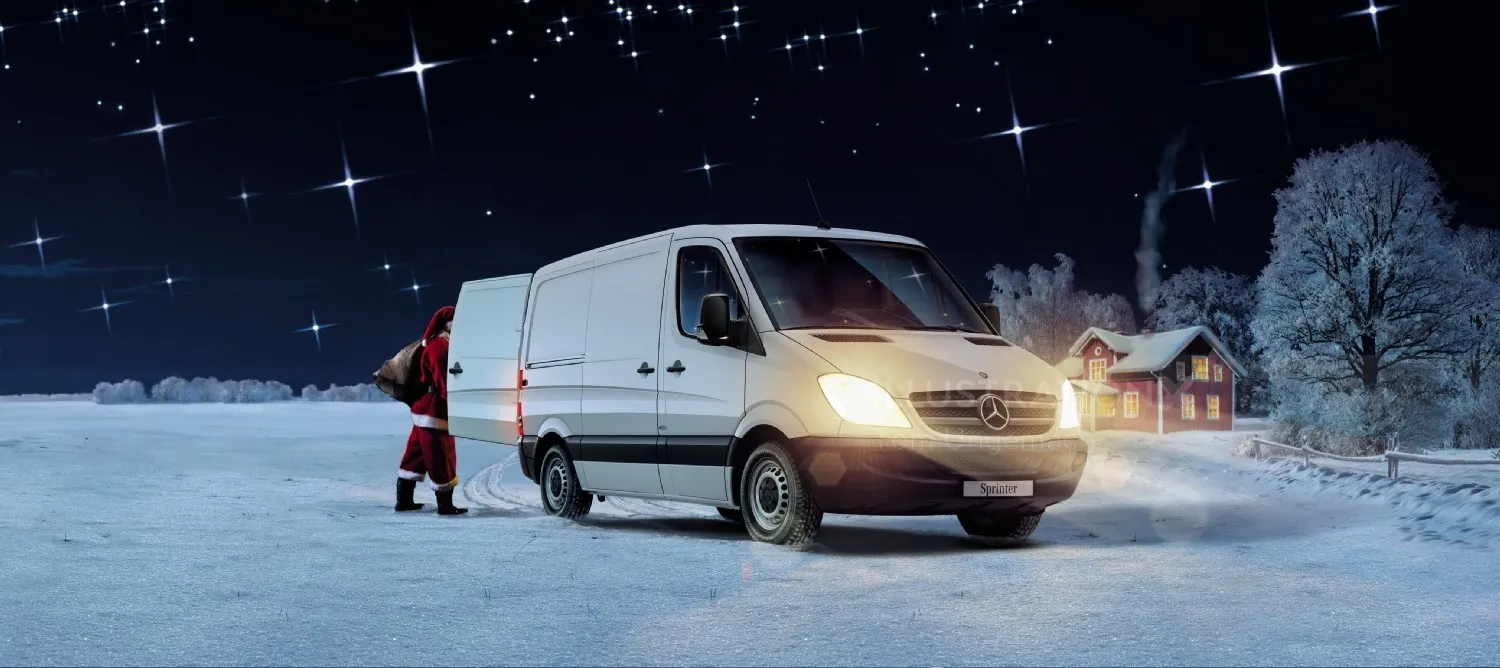 Santa Claus loading gifts into a white van on a snowy night by a house by Tom Ungemach