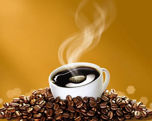 Steaming coffee cup with coffee beans on table by Tom Ungemach
