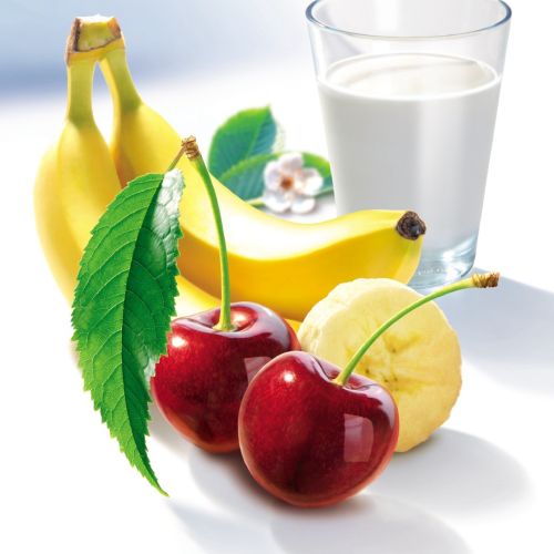 Bright cherries with leaves, bananas, and a glass of milk by Tom Ungemach