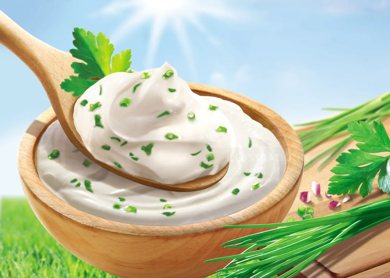 Creamy herb-infused sour cream in wooden bowl and spoon by Tom Ungemach