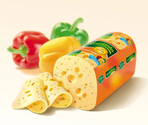 Sliced Swiss cheese with red, yellow, and green bell peppers by Tom Ungemach