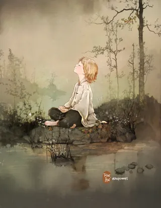 Child sitting cross-legged near calm river with mist and trees in background.