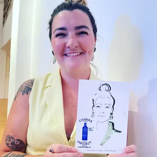 Smiling woman holds live event portrait drawing by Veronica Collignon