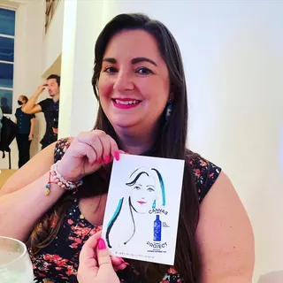 Woman holding caricature drawing by Veronica Collignon