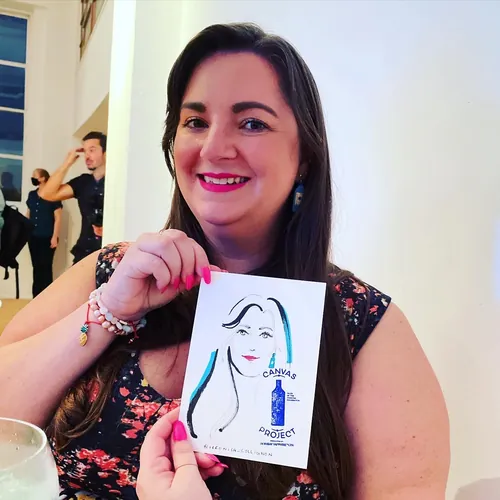 Woman holding caricature drawing by Veronica Collignon