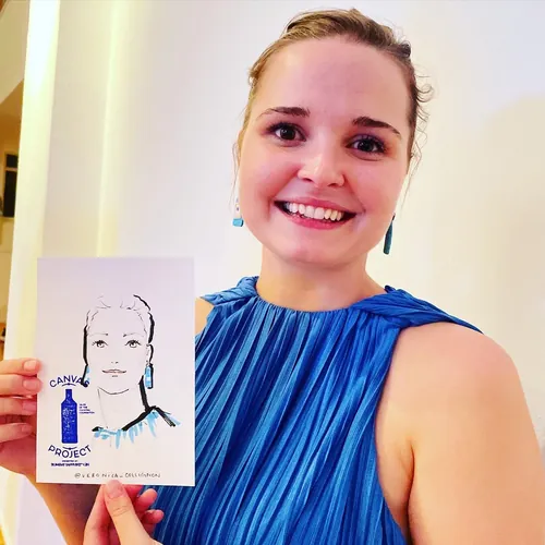 Smiling woman in blue dress holding a sketch portrait, by Veronica Collignon