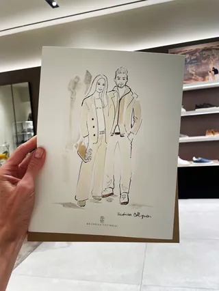 Fashion illustration of a man and woman held in a hand