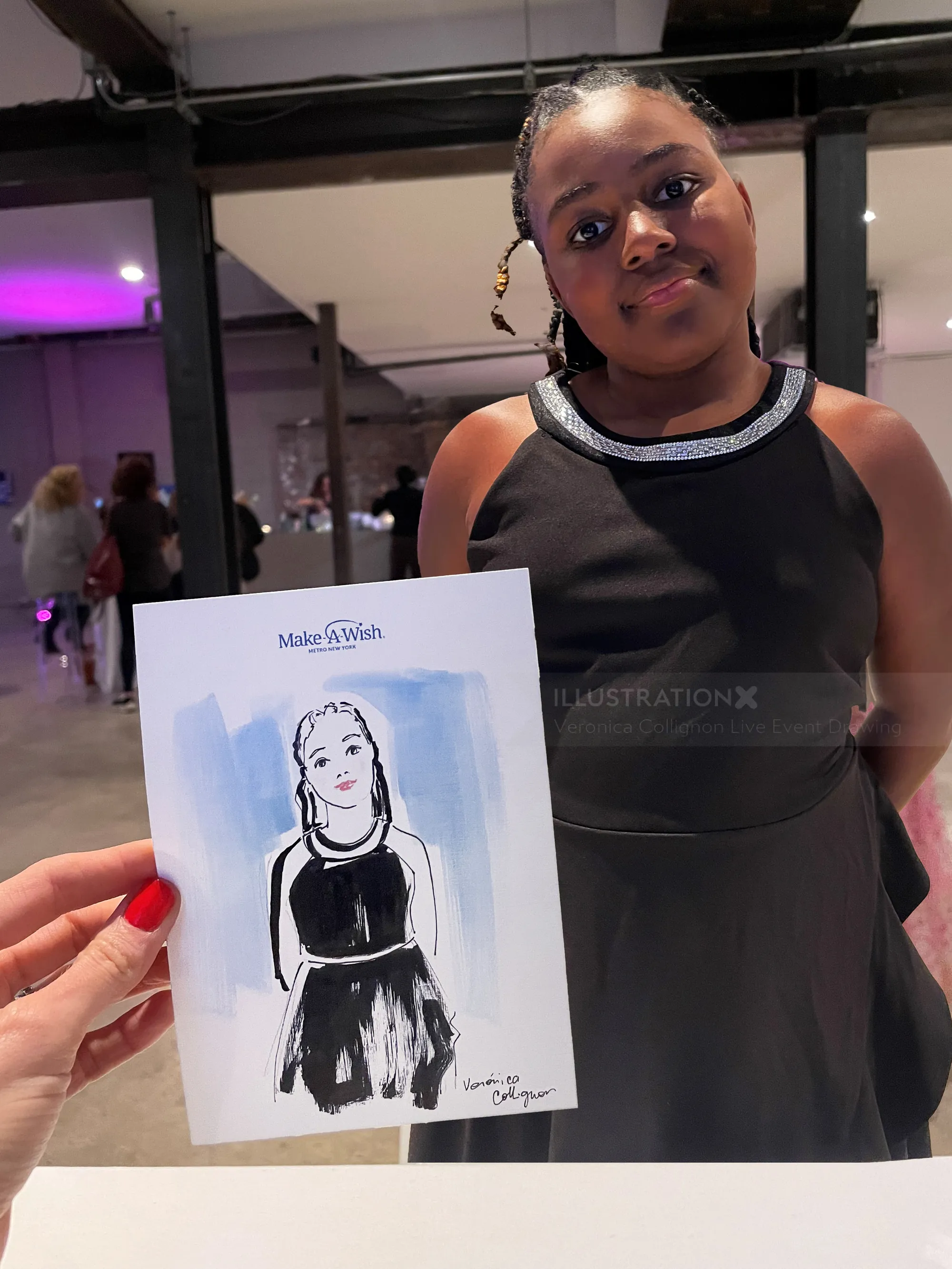Girl in black dress posing with a caricature sketch of herself